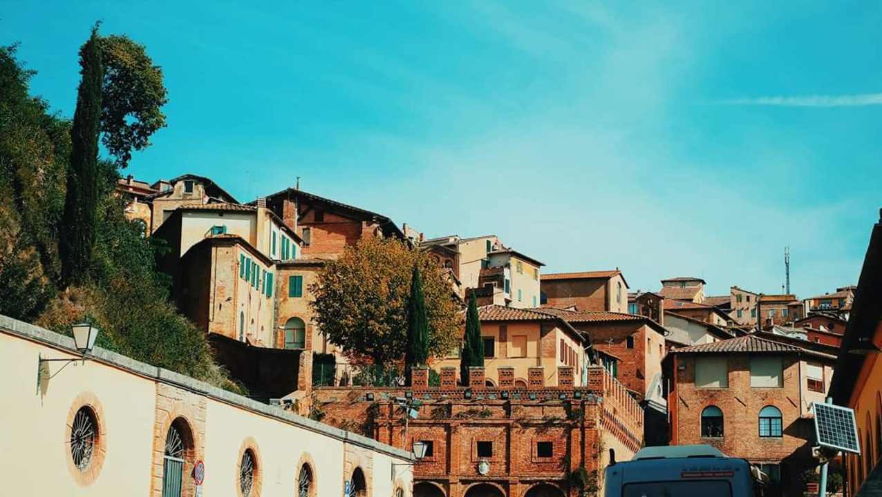 Scenic view of hillside buildings under a bright blue sky.