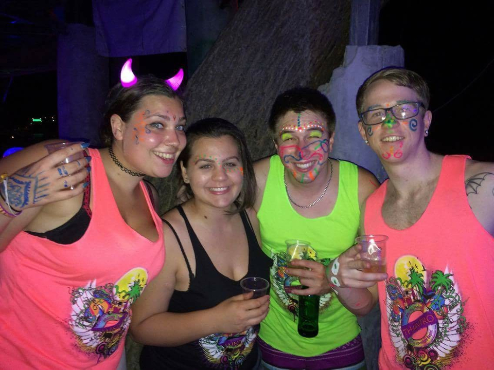 Group with neon face paint at night.