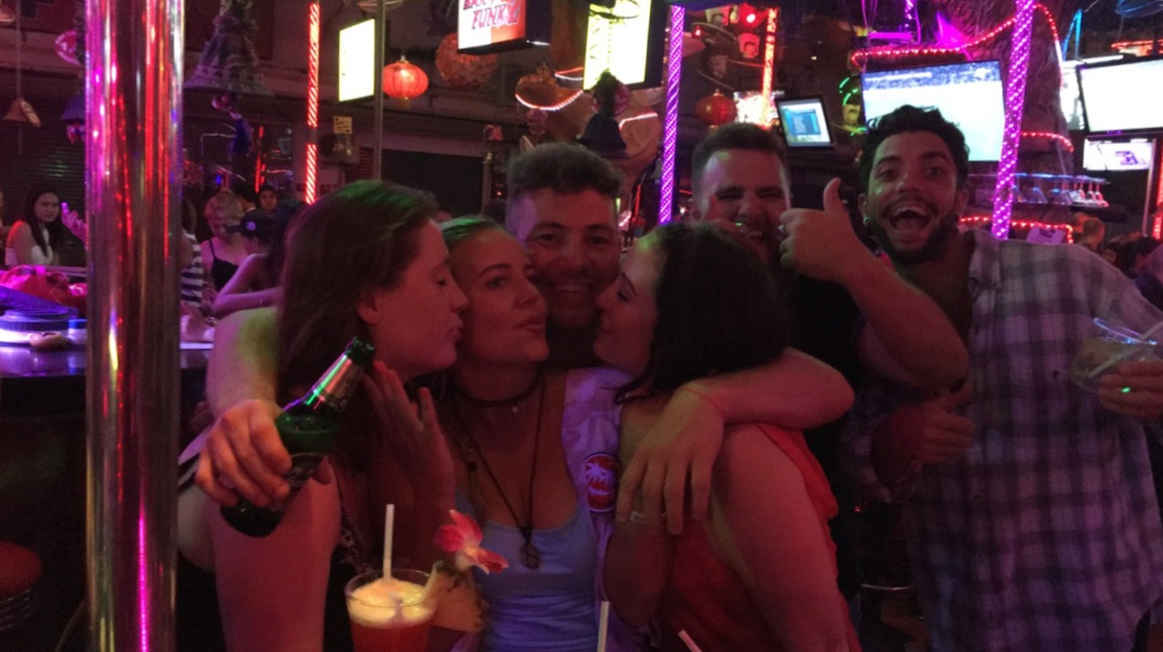 Group of people enjoying night out at a bar.