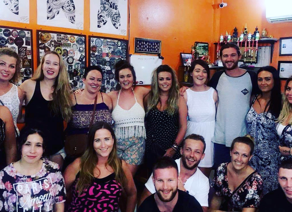 A group of friends posing together inside a decorated room.