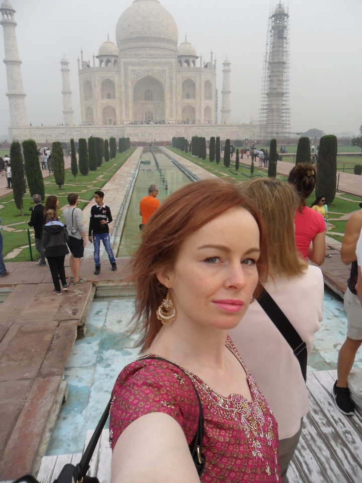 Close-up of a woman at the reflecting pool leading to the Taj Mahal.
