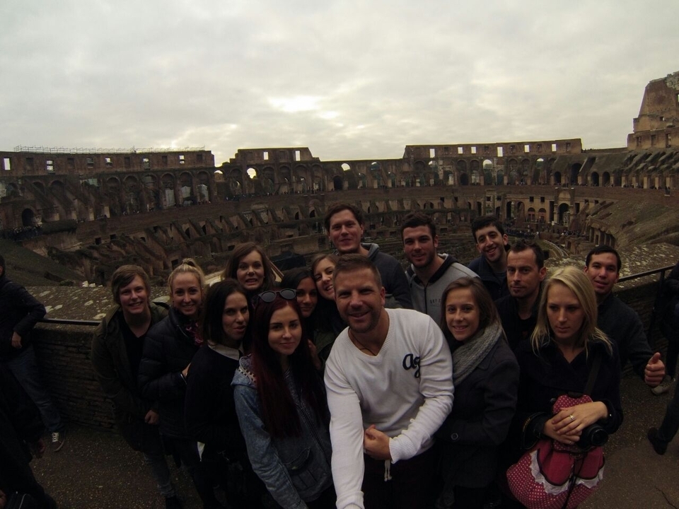 People posing inside an ancient amphitheater.