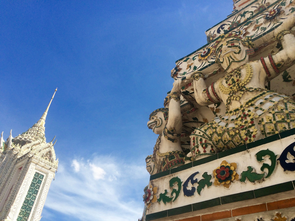Close-up of a temple with mythological statues and ornate decorations.