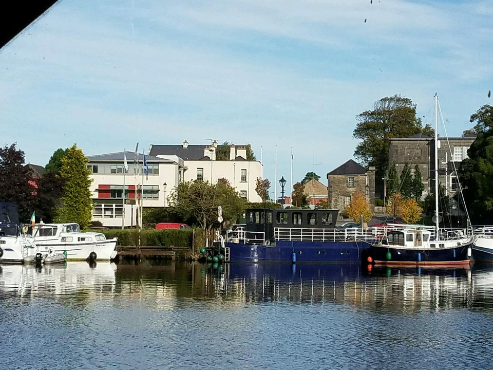 Boats docked at a scenic riverside location.