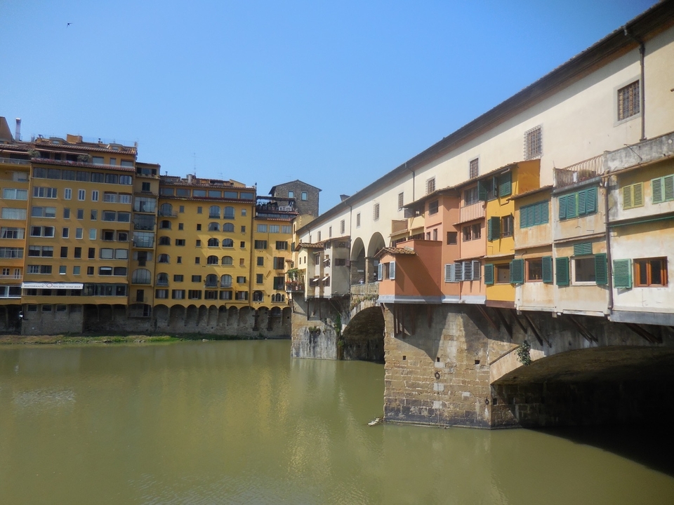Bridge and historical buildings over a river.