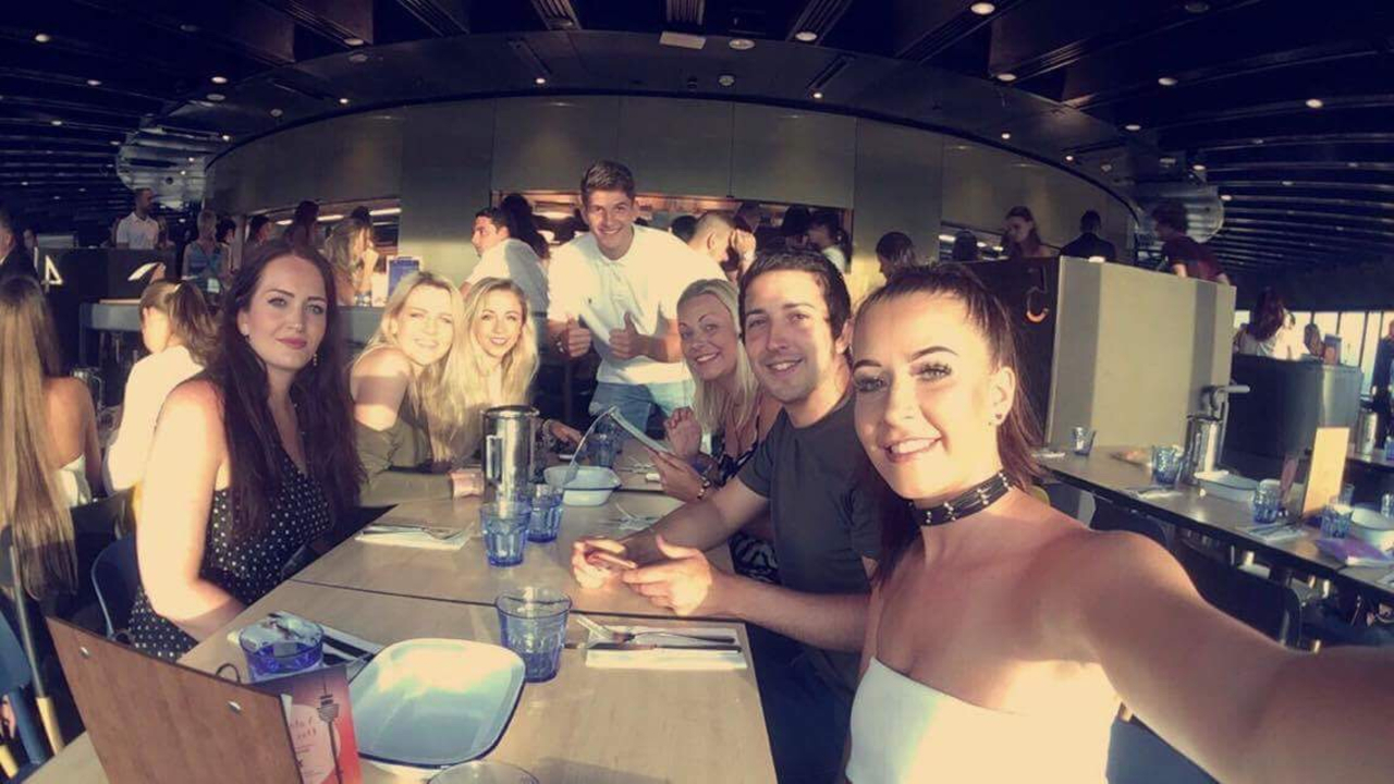 Friends dining in a restaurant with a scenic view