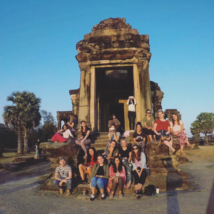 Group posing in front of a historical temple