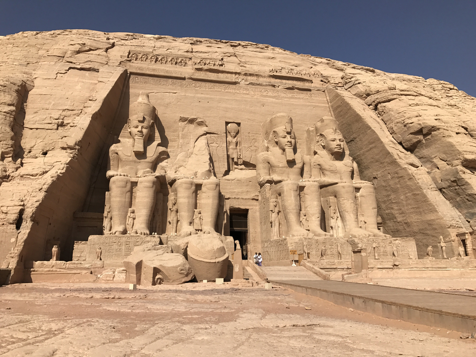 Exterior view of the Abu Simbel temples with large statues.