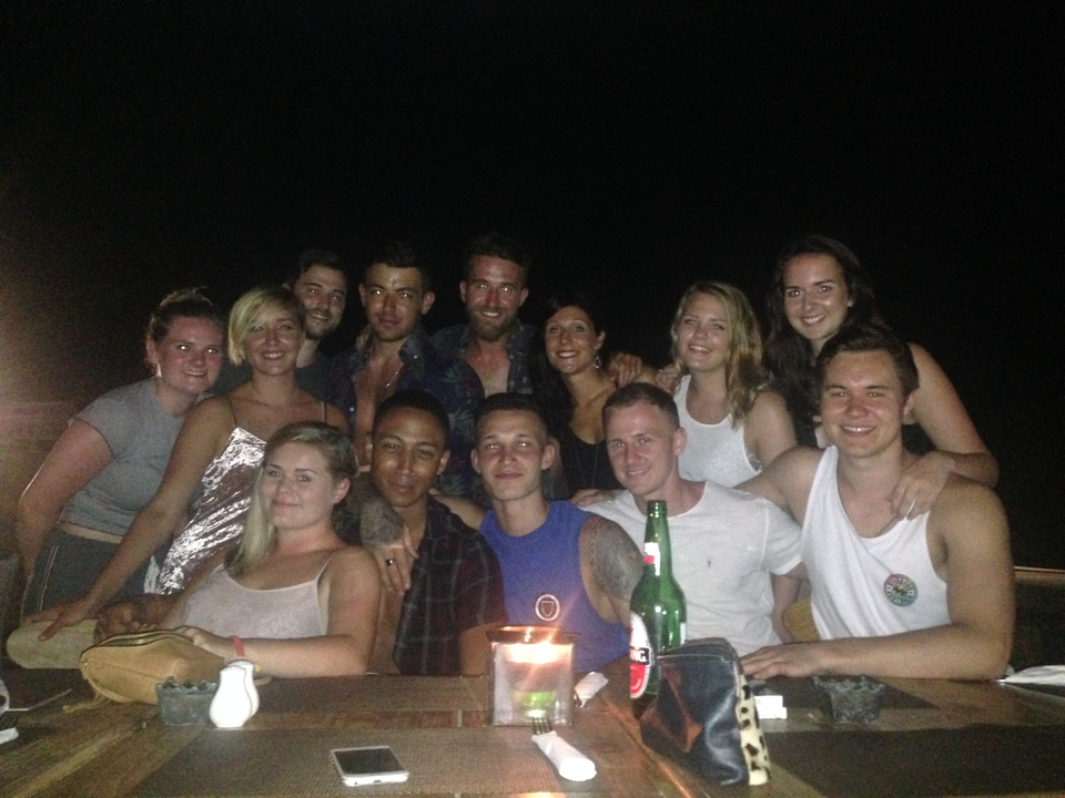 Group of people posing for a night dinner.