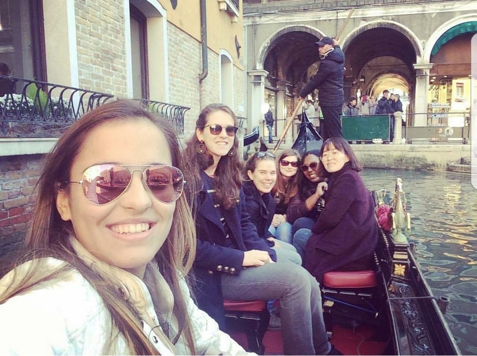 Group of people in a gondola on a Venetian canal