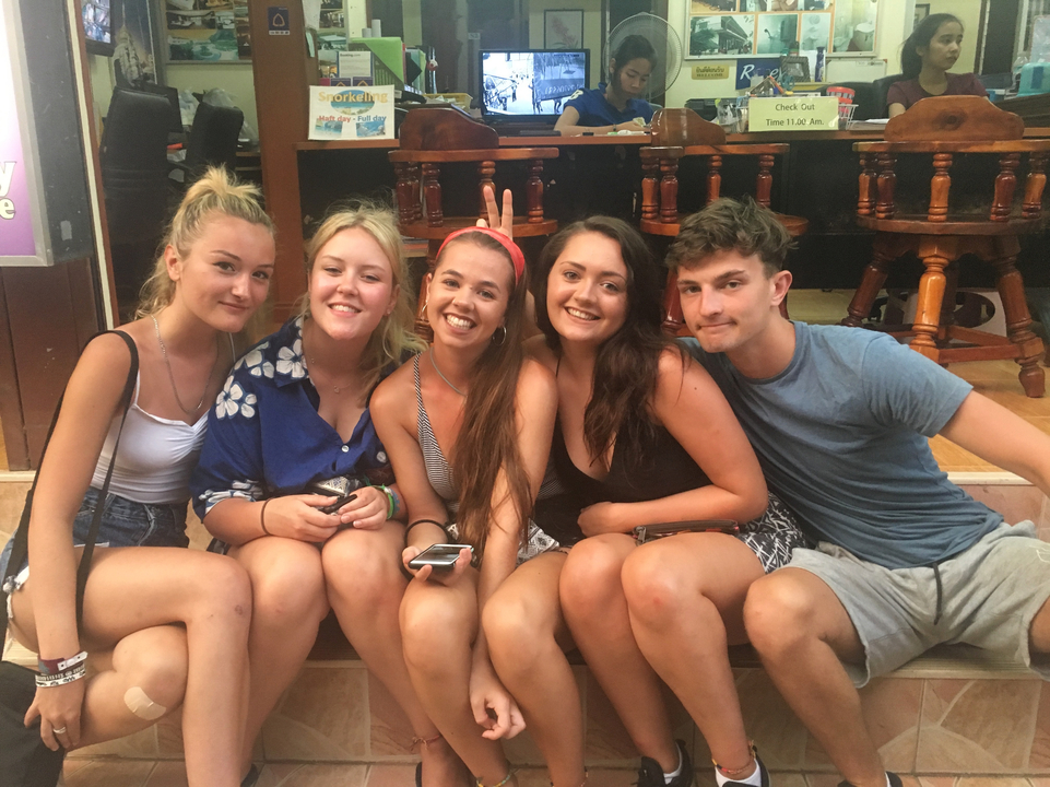 Group of friends posing together outside.