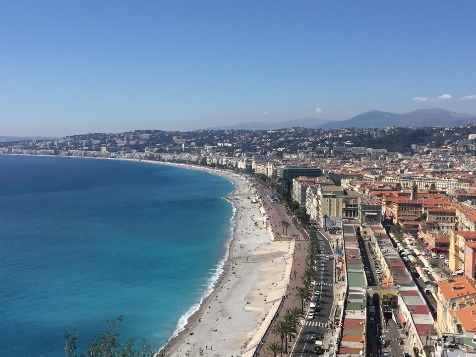 Vue aérienne d'une plage et de la côte d'une ville avec une mer bleue claire.