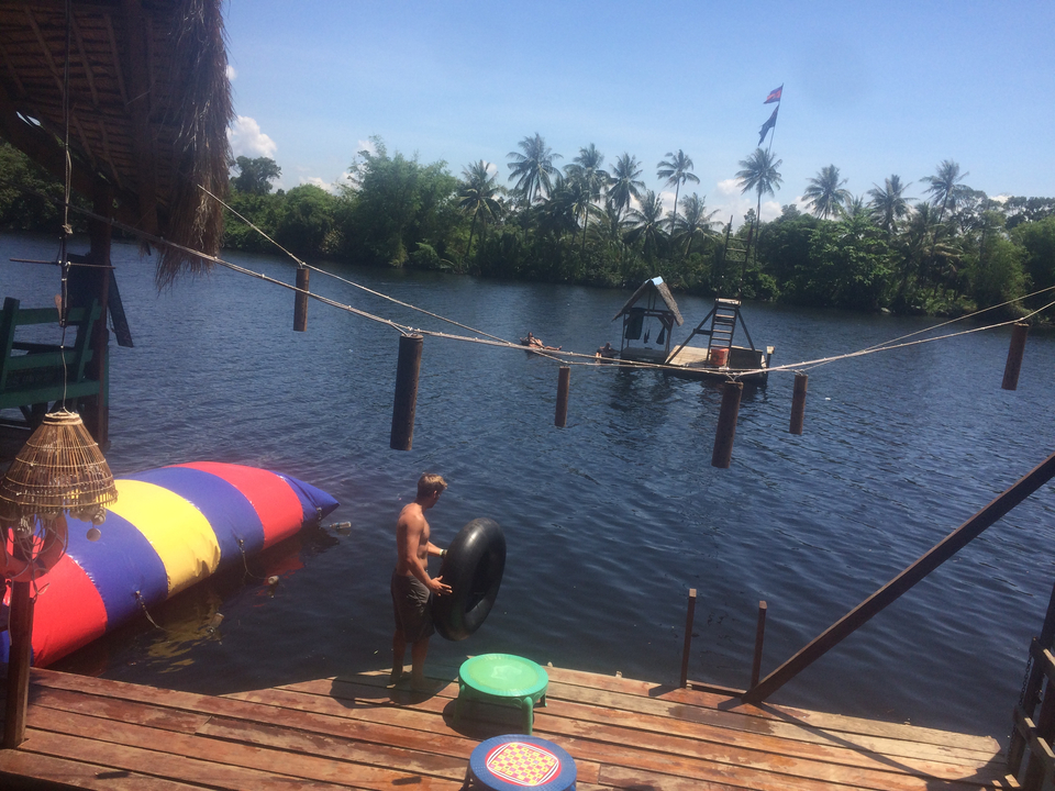 People engaging in water activities by the river.