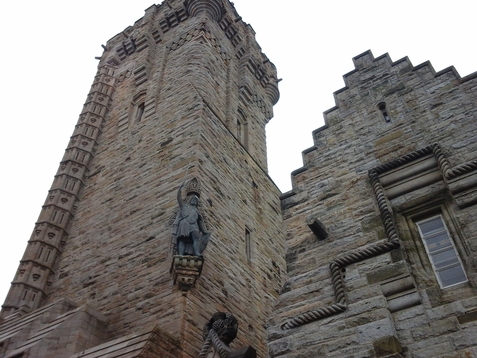 Detailed view of a historic stone building with sculpted figures.