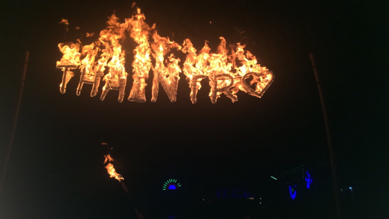 A fiery sign with 'THAINTRO' written in flames.