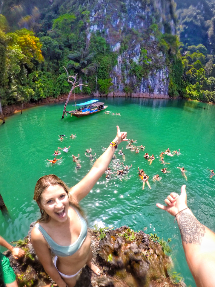 Aerial view of swimmers in clear, green water.