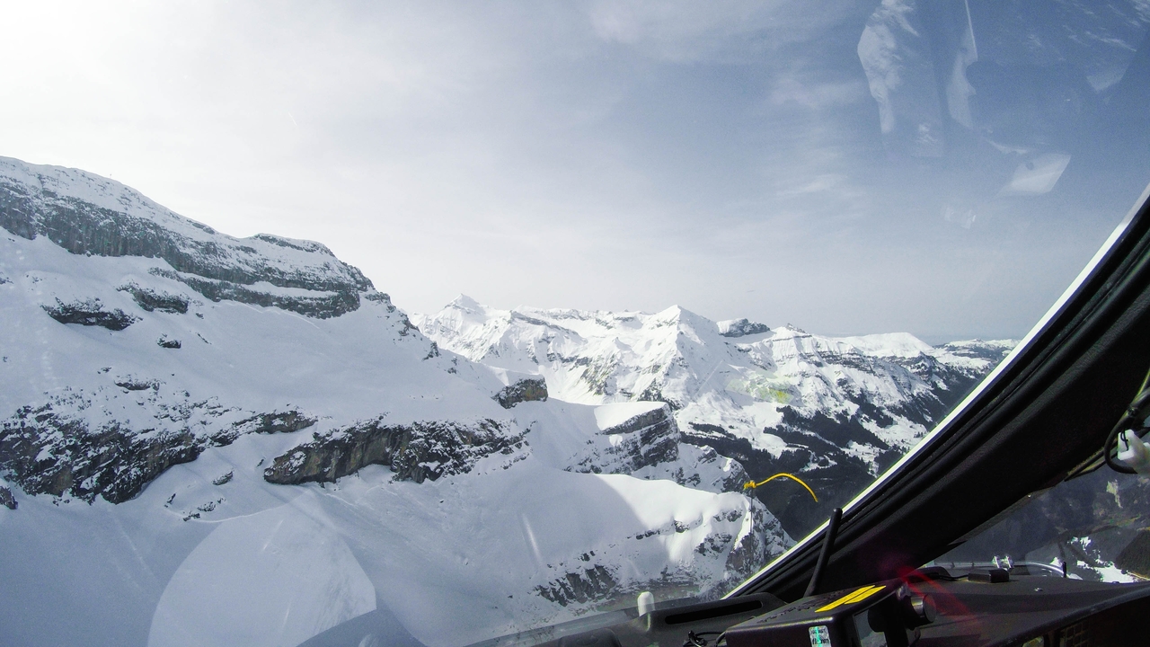 Aerial view of snow-capped mountains from a cockpit.