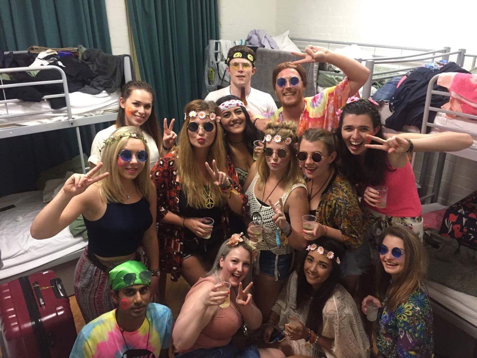 Group of people posing in a room decorated for a party.