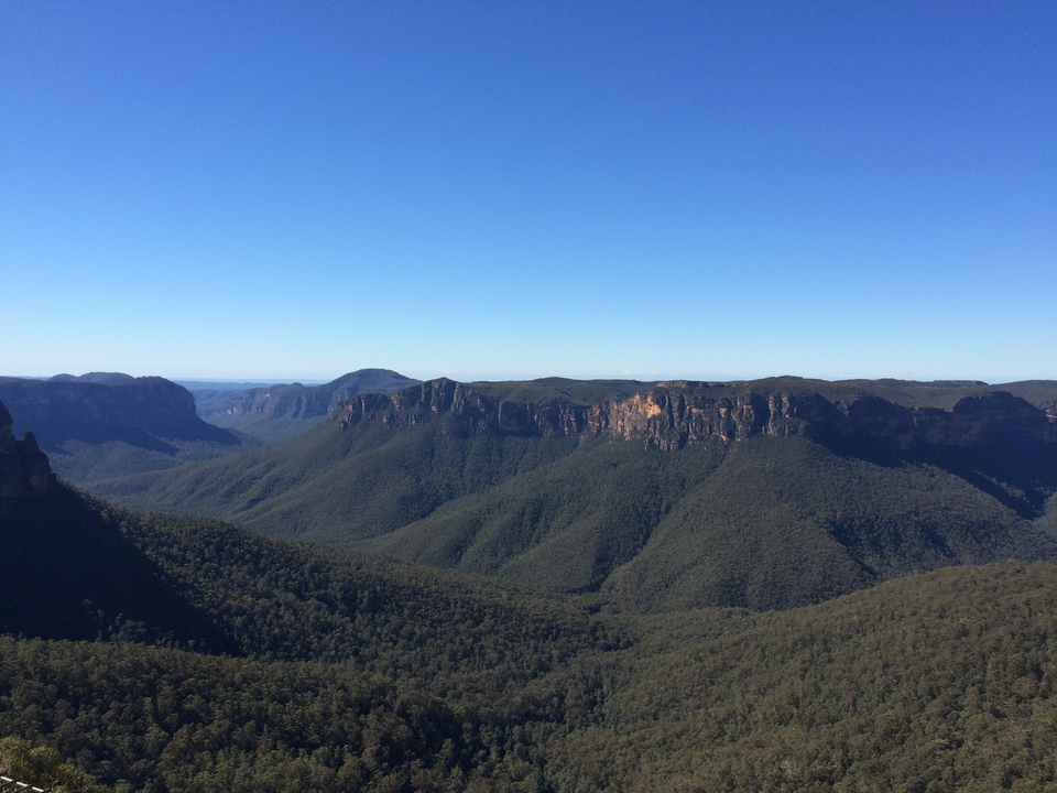 Vast mountain range under a clear blue sky.