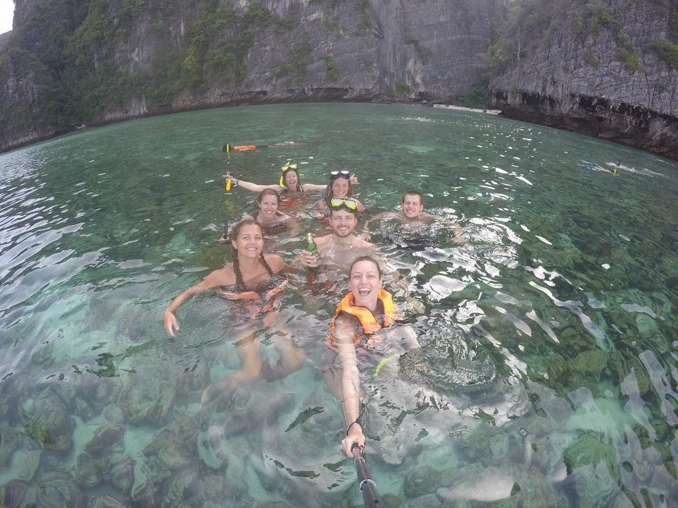 People enjoying themselves while swimming in clear water.