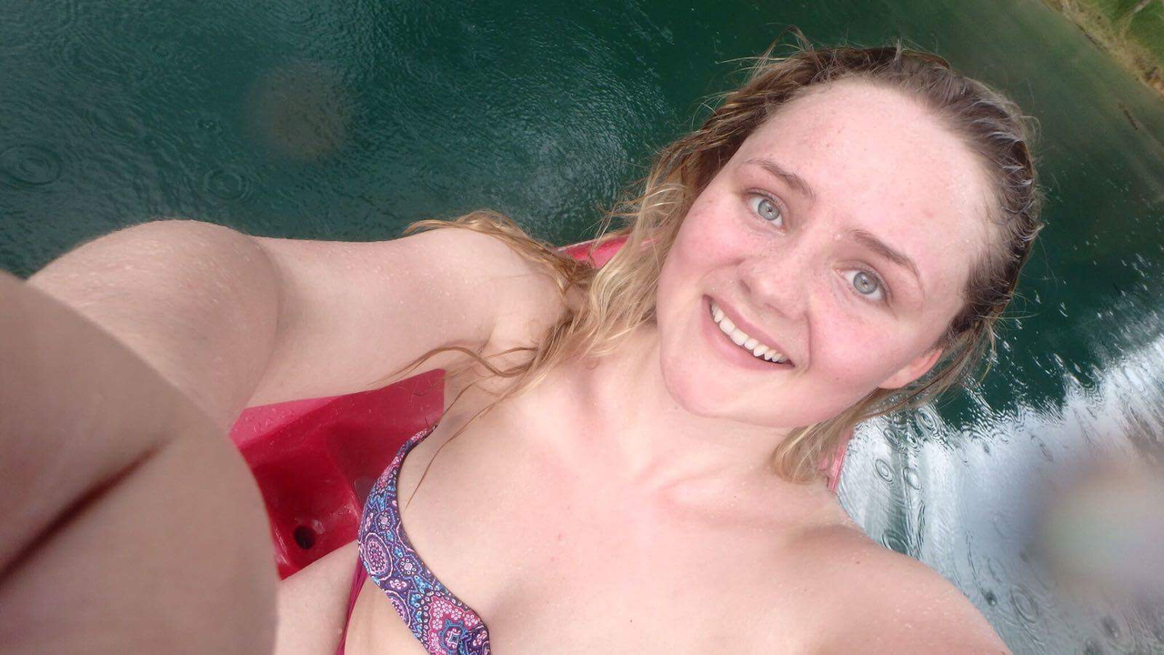 Selfie of a person kayaking on a lake.