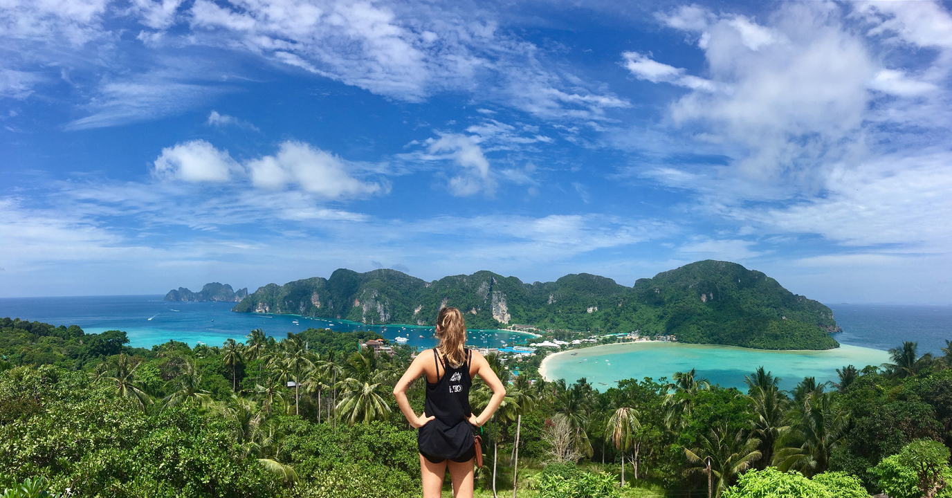 Woman overlooking a stunning panoramic view of a coastal island.