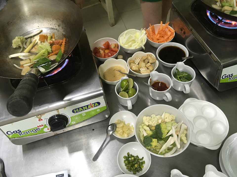 Cooking utensils and ingredients set up for a cooking class.