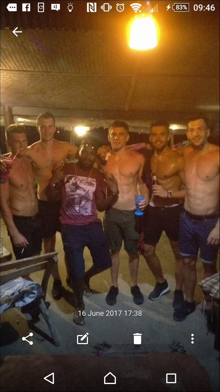 Group of men posing at night.