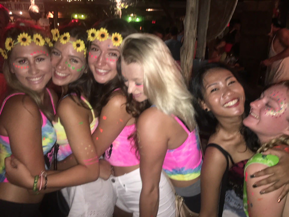 Friends enjoying a party in colorful costumes.