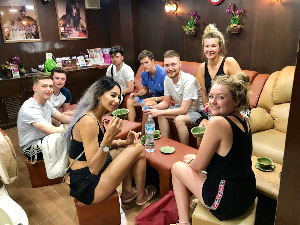 Group of friends sitting and enjoying a drink indoors.