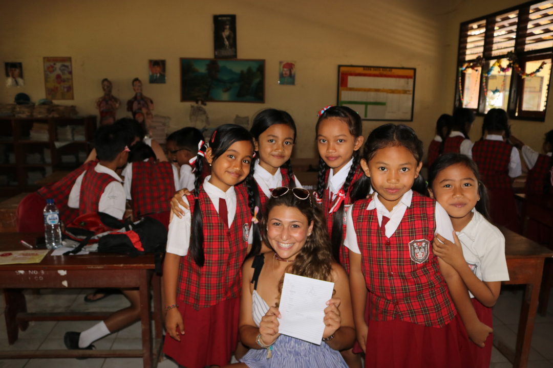 Salle de classe avec des enfants et un enseignant posant pour une photo.