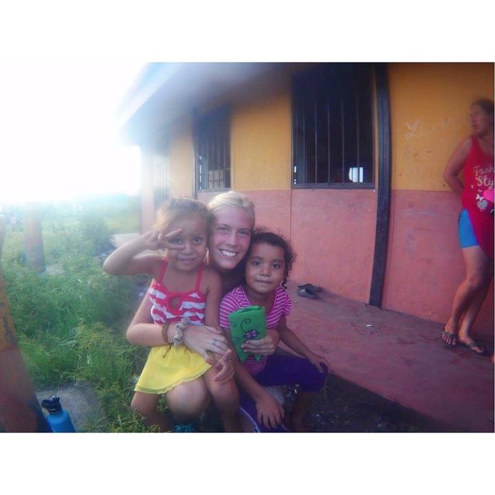 Woman and two children smiling for a photo.