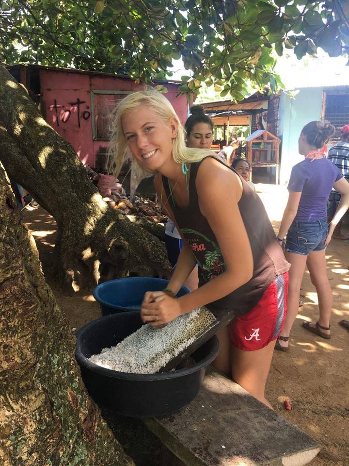 Woman working with a sieve at a local community event.