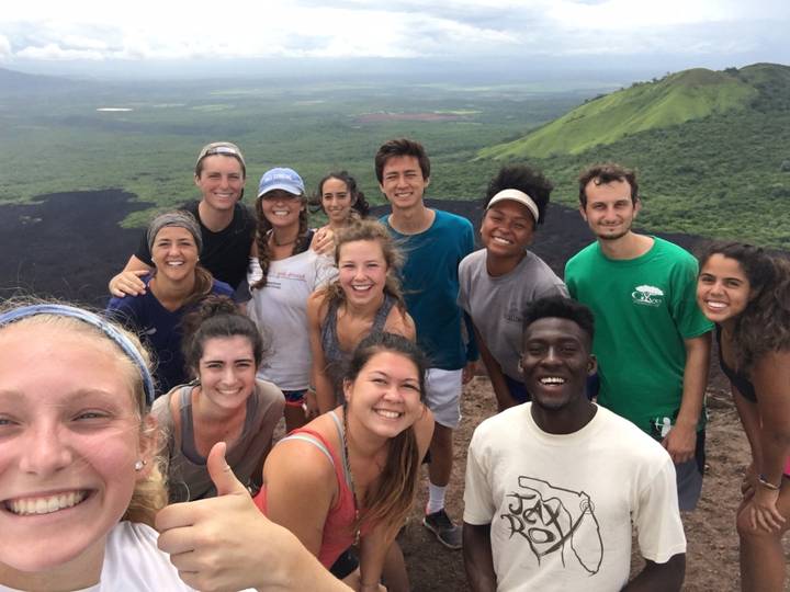 Group of people on a hilltop with a scenic view