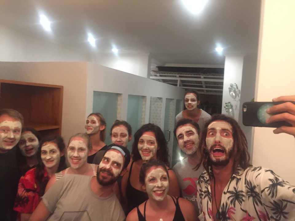 Groupe de personnes à l'intérieur portant des masques, prenant un selfie.