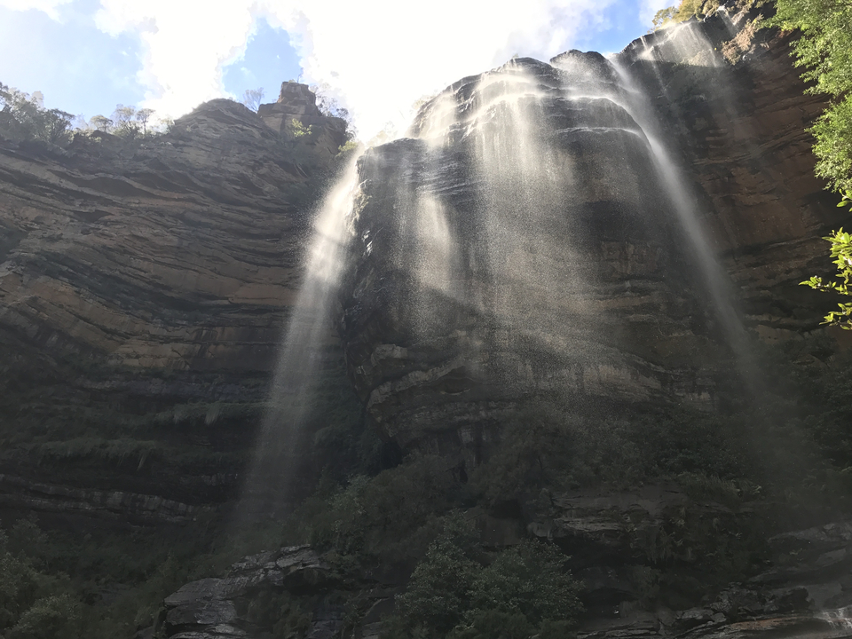 Waterfall cascading over rocky cliffs.