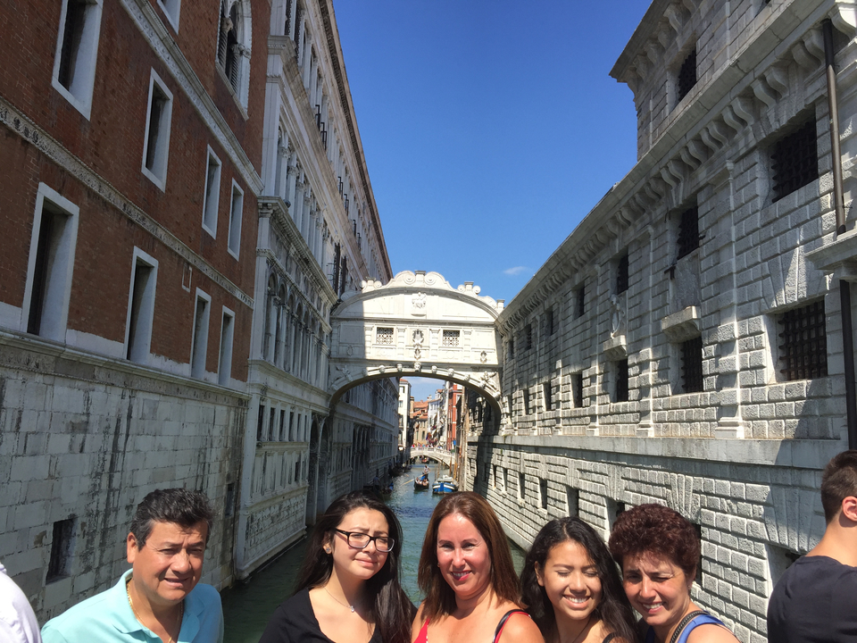 Group of people near the Bridge of Sighs in Venice.