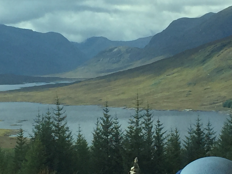 Mountains and a valley with a lake in the distance