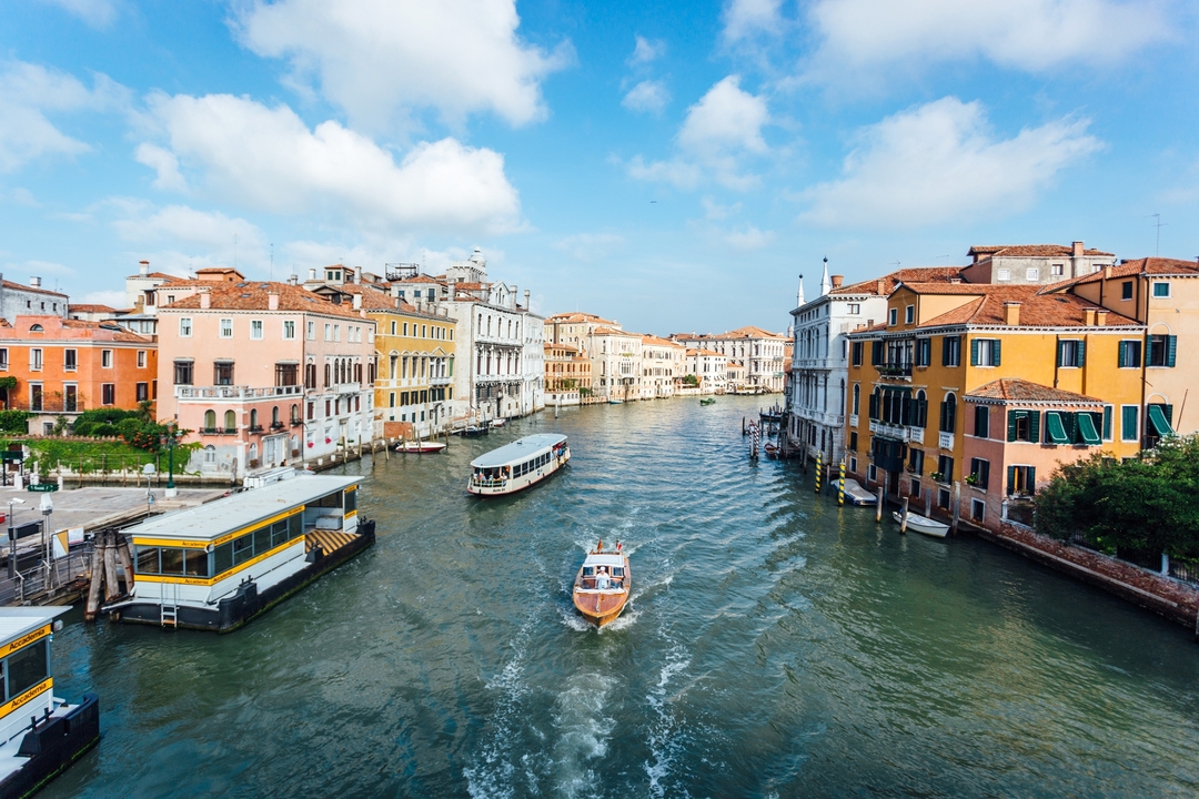 Scenic view of a canal with boats and colorful buildings.