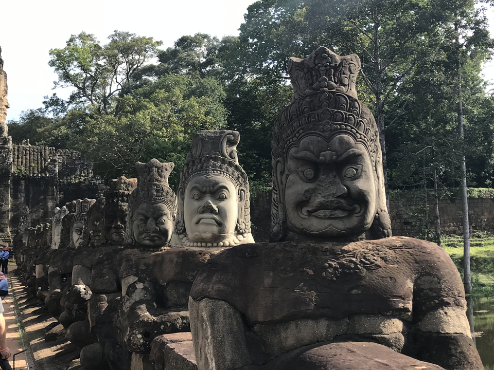 Ancient stone statues lined in succession.