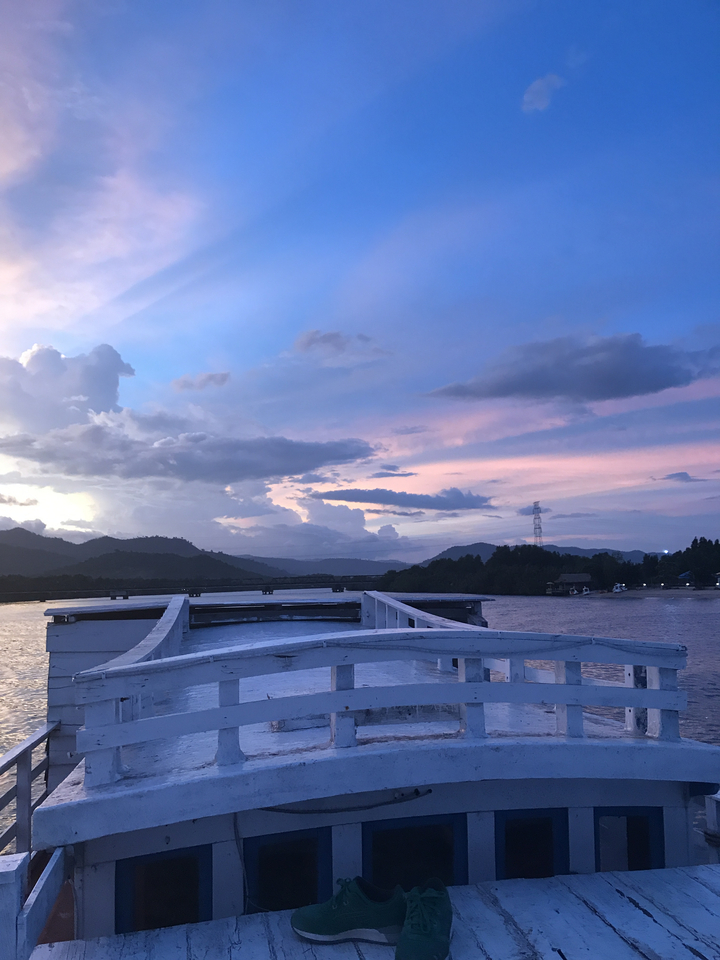 Beautiful sunset over a river with mountains in the background.