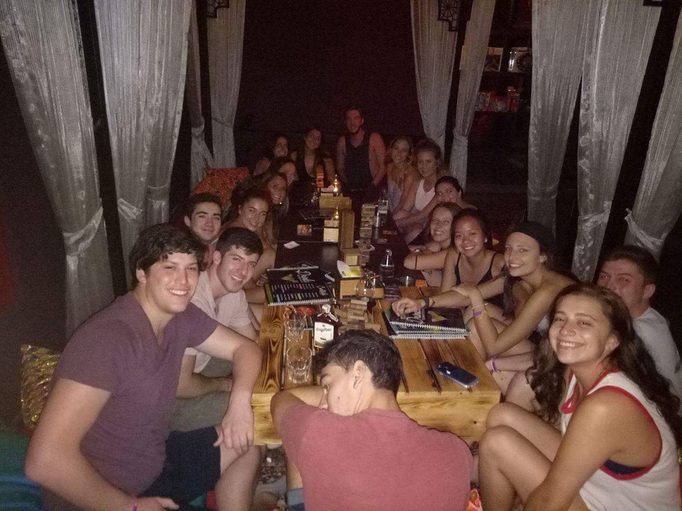 A group of people gathered around a table in a dimly lit setting.