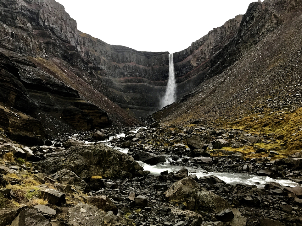 Waterfall cascading down a steep rocky cliff.