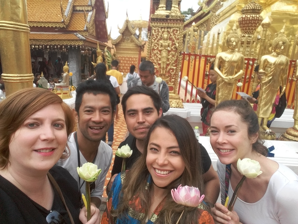 Selfie de groupe devant les statues dorées d'un temple.
