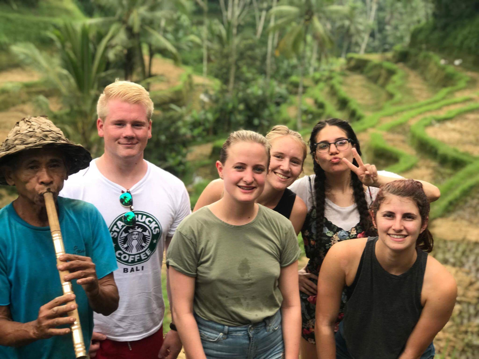 Group of young people with a local by rice terraces.