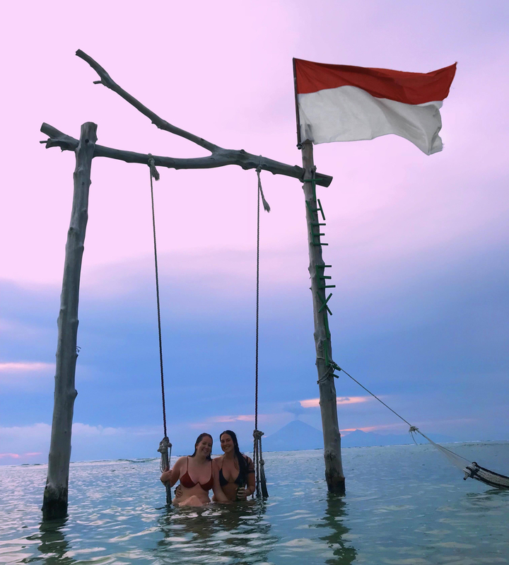 Wooden swing structure with a blue sky background.