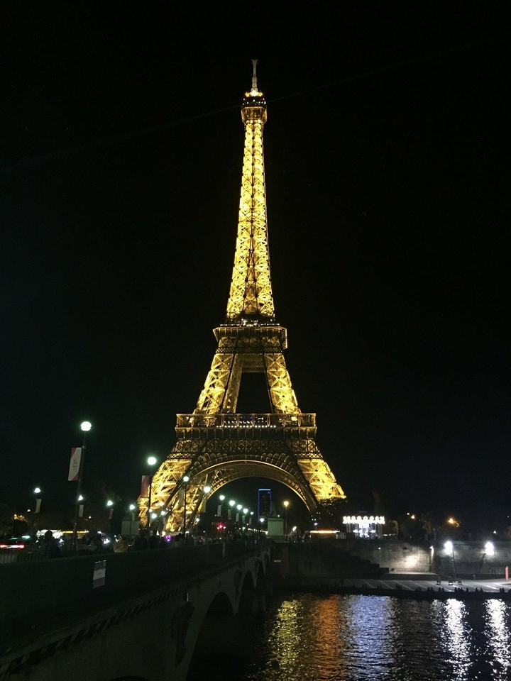 Illuminated Eiffel Tower at night in Paris.