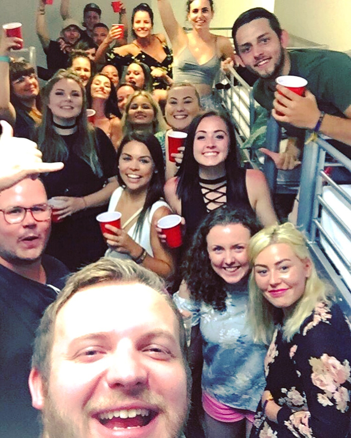 Group of people at a party holding red cups.