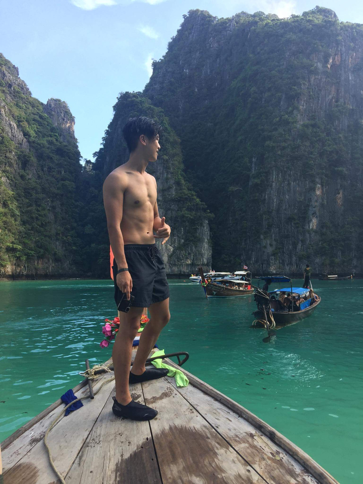 Person on a boat with crystal clear water.