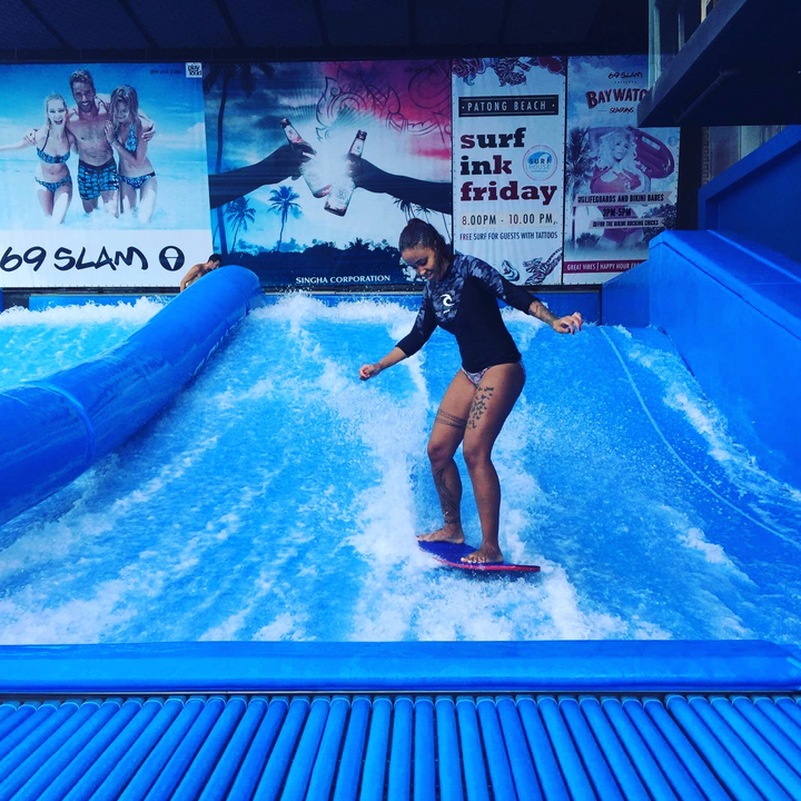 Person surfing on an artificial wave.
